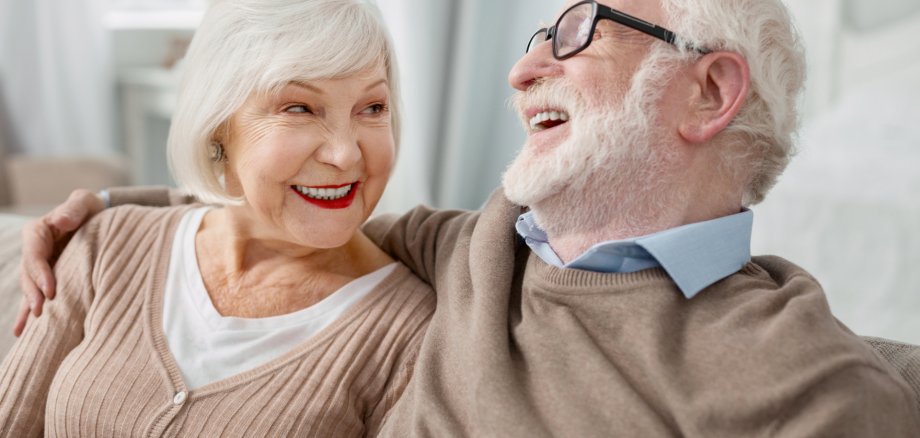 Cheerful elderly man hugging his wife Cheerful elderly man hugging his wife