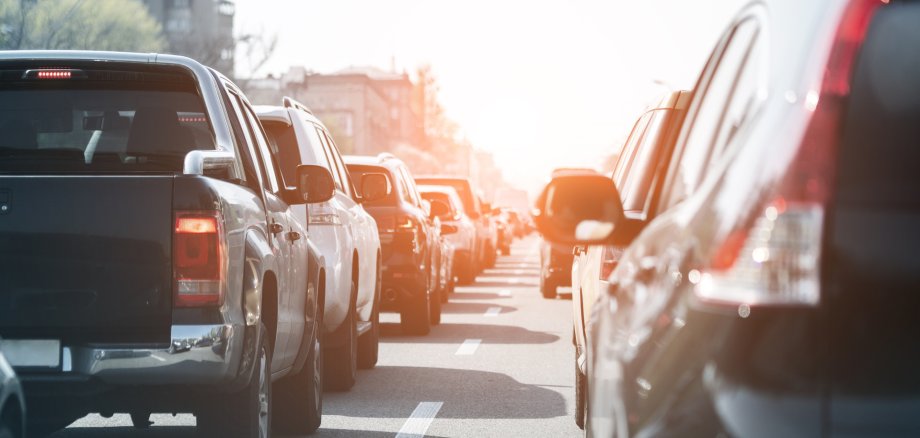 Evening traffic jam on busy city highway. Rows of car stck on road due to crush accident. Sunset metropolis rush hour scene
