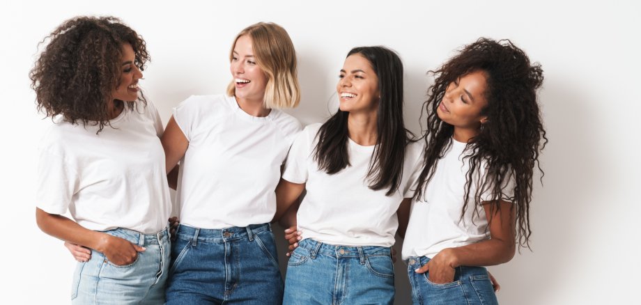 Optimistic cheery young women multiracial friends