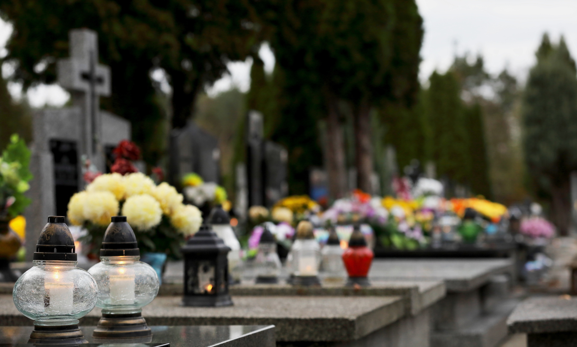 bouquet of flowers in a vase at the cemetery, candles on the gra bouquet of flowers in a vase at the cemetery, candles on the gra