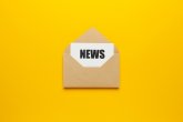 Address mailing of news by e-mail. Advertising message on yellow background. Das Wort "News" aus Holzbuchstaben.