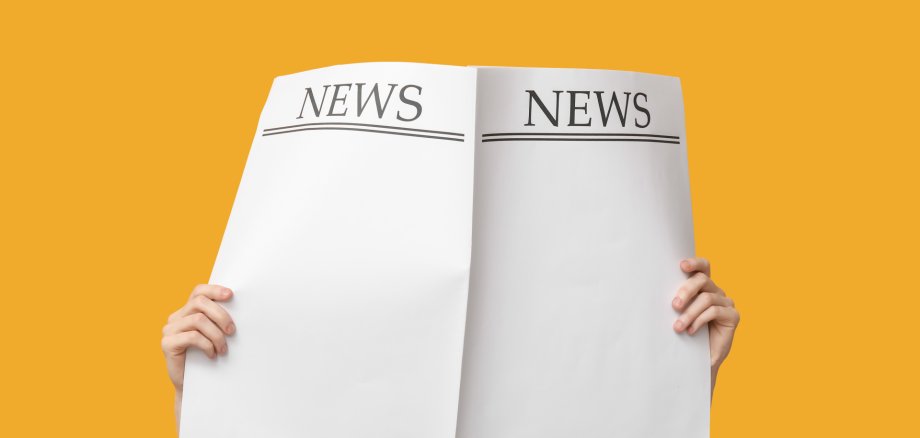 Woman with blank newspapers on yellow background Woman with blank newspapers on yellow background
