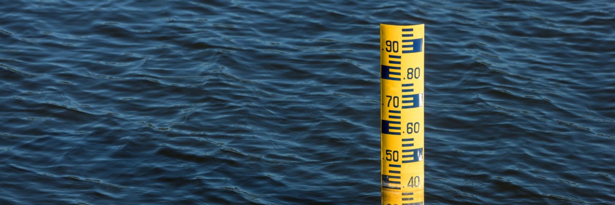Water level meter located in the water of the dam. Concepts for natural resources. Water level gauges in the background is the reservoir of water Water level meter located in the water of the dam. Concepts for natural resources. Water level gauges in the background is the reservoir of water