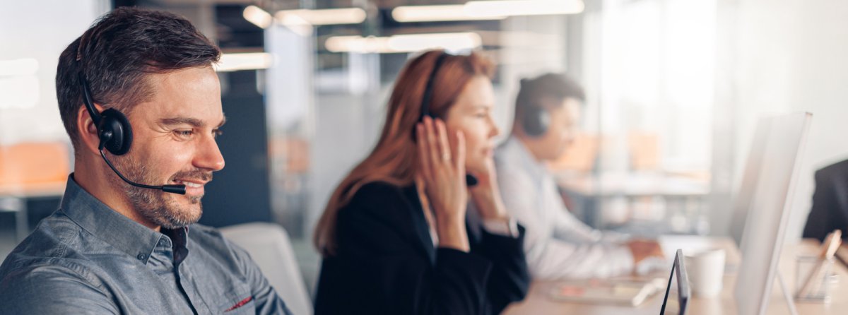 Nahaufnahme von Service-Mitarbeitern mit Headset im Telefongespräch