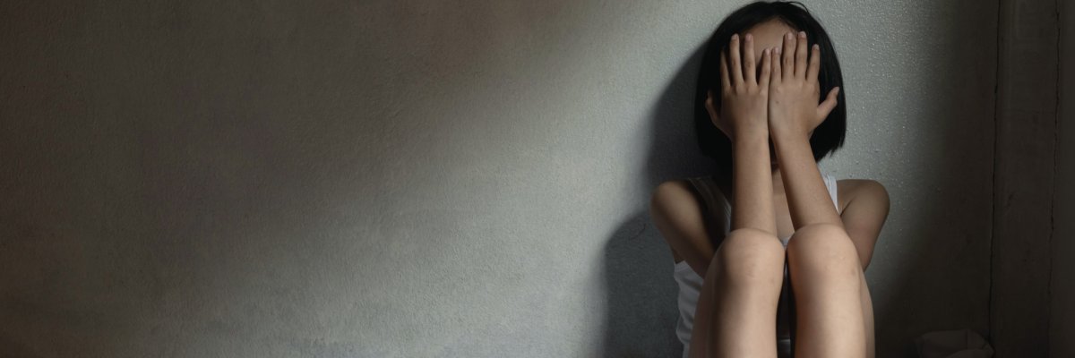 Stop violence and abused children. Sad little girl sitting in ro