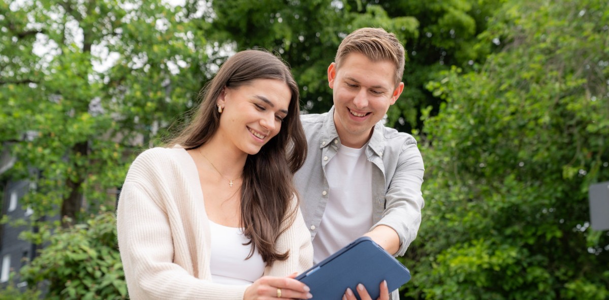 Junge Mitarbeitende der Stadt Overath bei der gemeinsamen Arbeit mit einem Tablet