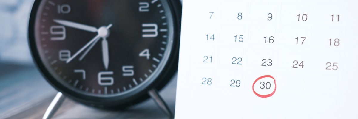 deadline concept with calendar and alarm clock on table