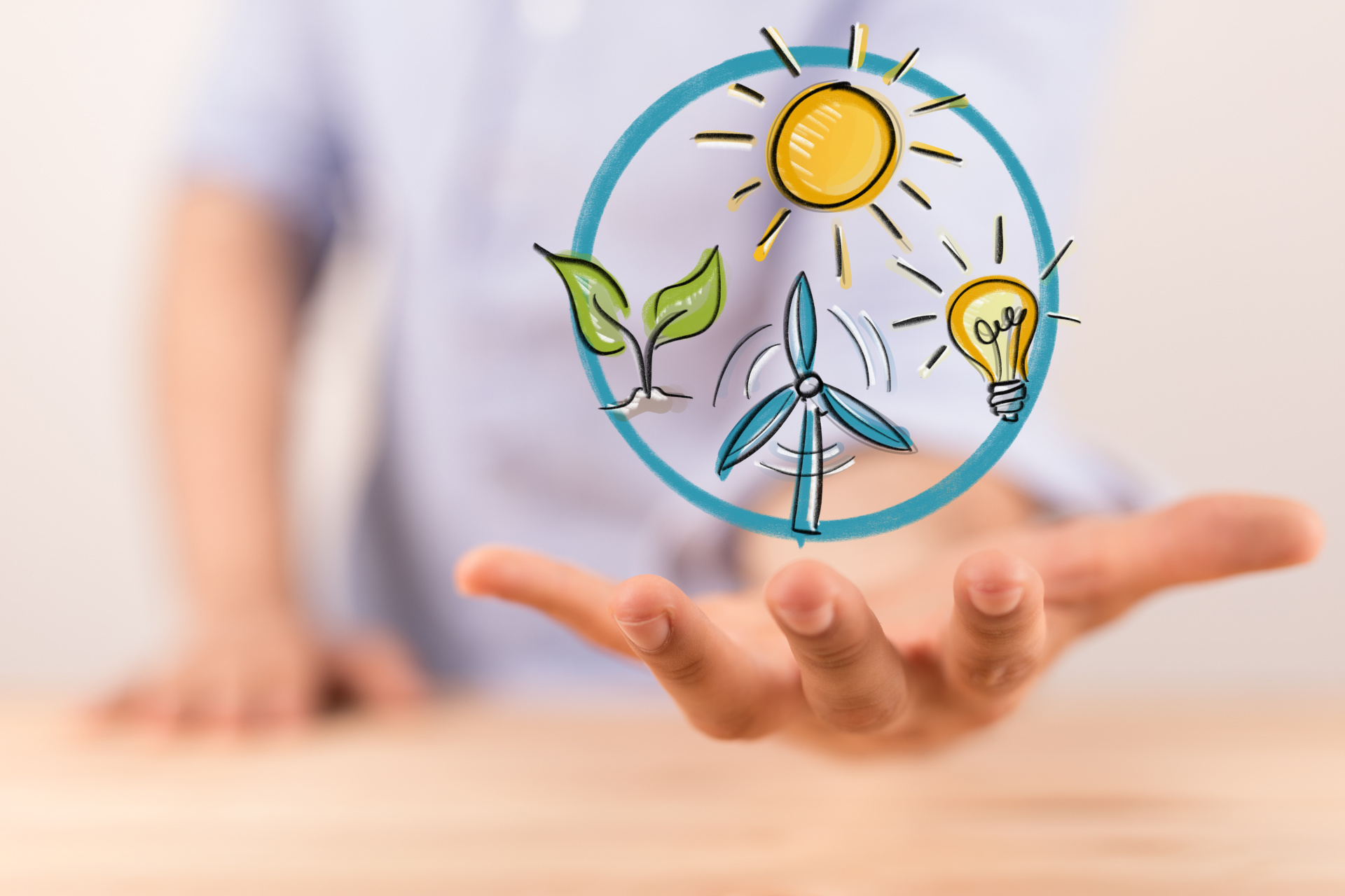 Sonne, Windrad und Blätter über einer Hand